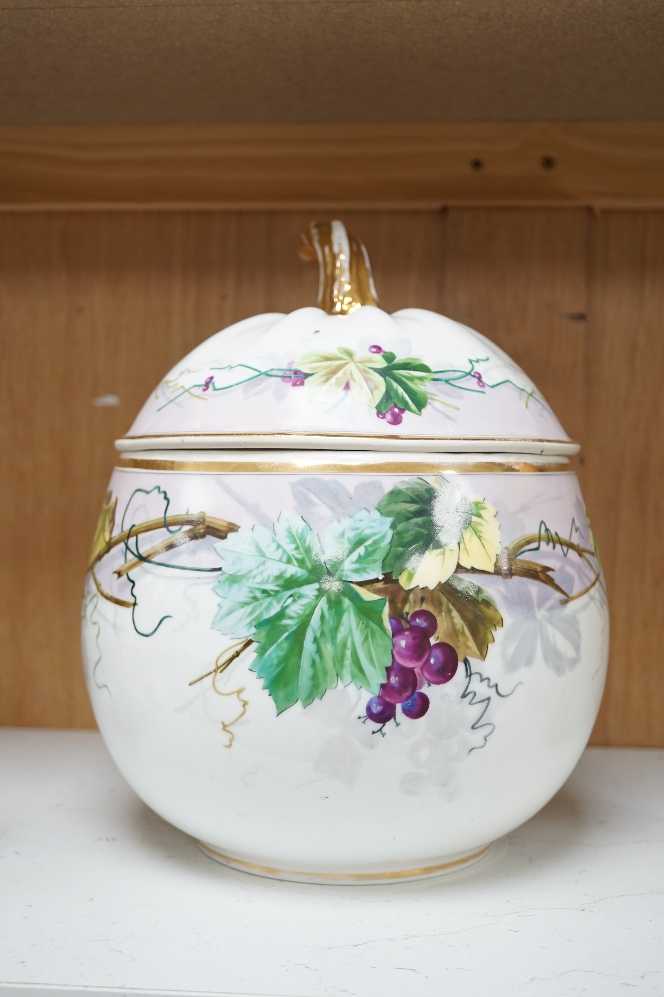 A Paris porcelain grape and vine painted punch bowl and cover, 27cm high. Condition - fair to good.